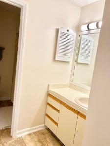 a bathroom with a sink and a mirror at Golf Front SFH, 3 BR, 2 BA, 4 beds, sleep 6 on Pinehurst #6 in Pinehurst