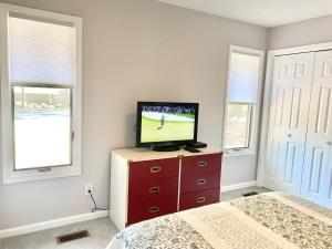 a bedroom with a tv on a dresser with a bed at Golf Front SFH, 3 BR, 2 BA, 4 beds, sleep 6 on Pinehurst #6 in Pinehurst