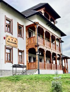 a large house with a large deck on top of it at Maramures BELVEDERE in Petrova