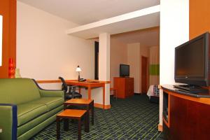 a hotel room with a couch and a tv at Fairfield Inn & Suites Tehachapi in Tehachapi