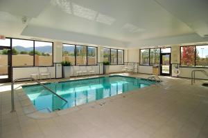 a large swimming pool with chairs in a building at Fairfield Inn & Suites Tehachapi in Tehachapi