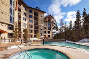a swimming pool in front of a apartment building at The Westin Monache Resort, Mammoth in Mammoth Lakes