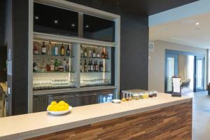 a bar with a bowl of fruit on a counter at Courtyard by Marriott Cartersville in Cartersville