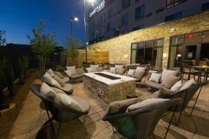 a patio with chairs and a fire pit in front of a building at Courtyard by Marriott Cartersville in Cartersville