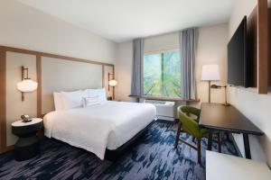 a hotel room with a bed and a desk and a window at Fairfield Inn & Suites by Marriott Lexington East/I-75 in Lexington