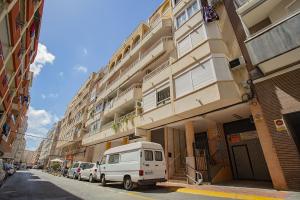 a white van parked in front of a building at 139 Lucias Beach Alicante Holiday in Torrevieja