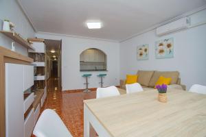 a living room with a table and a couch at 139 Lucias Beach Alicante Holiday in Torrevieja