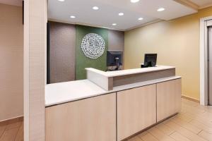 a reception desk in a hospital lobby with a green wall at Fairfield Inn & Suites Austin University Area in Austin