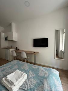 a bedroom with a bed with two towels on it at Noble Studio Apartments in Zagreb