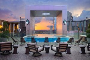 a building with a swimming pool on a building with chairs at The Westin Nashville in Nashville