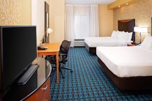 a hotel room with two beds and a flat screen tv at Fairfield Inn and Suites by Marriott Dallas Mansfield in Mansfield