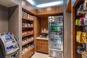 a kitchen with a refrigerator and a drink cooler at SpringHill Suites Anchorage Midtown in Anchorage