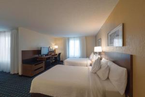 a hotel room with two beds and a desk at Fairfield Inn & Suites by Marriott Cleveland Streetsboro in Streetsboro