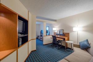 a hotel room with a desk and a bed and a room at Fairfield Inn & Suites by Marriott Cleveland Streetsboro in Streetsboro