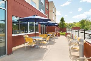 an outdoor patio with tables and chairs and umbrellas at Fairfield Inn & Suites by Marriott DuBois in DuBois