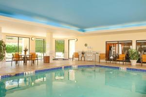 a swimming pool in a house with a dining area and a living room at Courtyard Hartford Manchester in Manchester