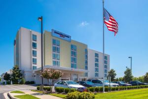 an american flag flying in front of a hotel at SpringHill Suites by Marriott Huntsville Downtown in Huntsville