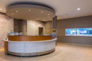 a lobby with a circular counter in a building at SpringHill Suites by Marriott Huntsville Downtown in Huntsville