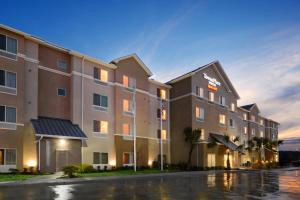 a rendering of a hotel at dusk at TownePlace Suites by Marriott Laredo in Laredo