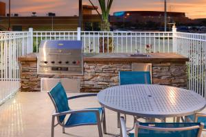 a patio with a table and chairs and a grill at TownePlace Suites by Marriott Laredo in Laredo