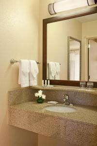 a bathroom with a sink and a mirror at SpringHill Suites by Marriott Medford in Medford