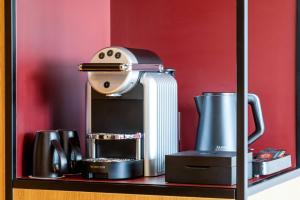 a coffee maker sitting on a shelf with other appliances at Renaissance Bordeaux Hotel in Bordeaux