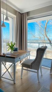 a desk with a chair in front of a window at Szerokie Wody Sea & Sand Ustka in Ustka