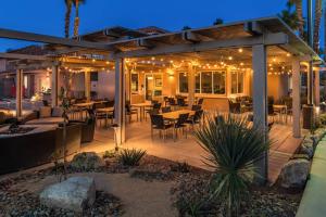 a patio with tables and chairs at night at Residence Inn Palm Desert in Palm Desert