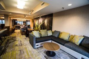 a living room with a couch and a table at Courtyard by Marriott Nashville at Opryland in Nashville