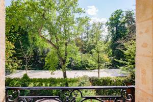 a bench in front of a park with a tree at Maison Labruyère Bordeaux - Jardin Public in Bordeaux +58 photos
