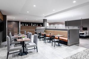 a restaurant with tables and chairs and a bar at TownePlace Suites by Marriott Whitefish in Whitefish
