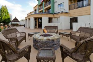 a patio with chairs and a fire pit in front of a building at Courtyard by Marriott Charlotte Lake Norman in Huntersville