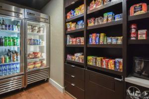 a room with a refrigerator filled with lots of food at Courtyard by Marriott Charlotte Lake Norman in Huntersville