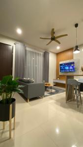 a living room with a couch and a tv at The Pinasti Villas in Tlekung