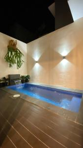 a swimming pool in the middle of a room at The Pinasti Villas in Tlekung