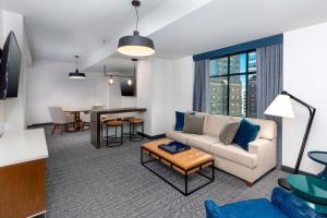 a living room with a couch and a table at Courtyard by Marriott Atlanta Midtown in Atlanta