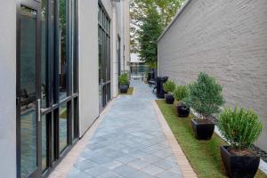 a walkway between two buildings with potted plants at Courtyard by Marriott Atlanta Midtown in Atlanta