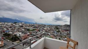 a balcony with a view of a city at Arboleda Real Hospedaje in Armenia