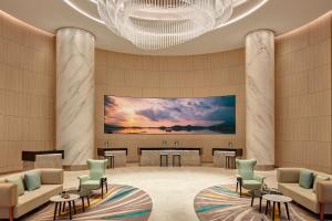 a lobby of a hotel with a large screen at Courtyard by Marriott Setia Alam in Setia Alam