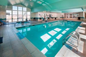 a large swimming pool with chairs in a building at Residence Inn Dover in Dover