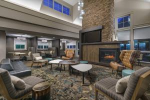 a lobby with couches and a fireplace at Residence Inn Burlington Colchester in Burlington