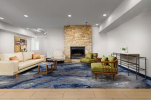 a living room with couches and a fireplace at Fairfield Inn and Suites by Marriott Houston The Woodlands in The Woodlands