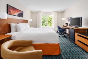 a hotel room with a large bed and a television at Fairfield Inn and Suites by Marriott Houston The Woodlands in The Woodlands