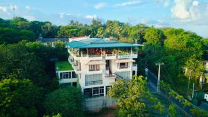 a building in the middle of a forest at Mount Rich Rumassala By JMS Group in Unawatuna