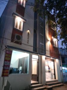 a building with lights on the side of it at PPH Living Royal Pride in Madurai