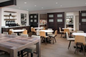 a restaurant with tables and chairs and a bar at Residence Inn by Marriott Lubbock Southwest in Lubbock