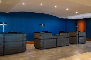 a room with blue walls and desks with lamps at Renaissance Concourse Atlanta Airport Hotel in Atlanta