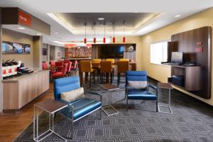 a lobby with a bar with chairs and a table at TownePlace Suites by Marriott Houston Galleria Area in Houston