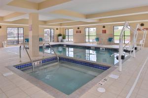 a large swimming pool in a building with a pool at TownePlace Suites by Marriott Gillette in Gillette