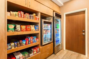 a walk in pantry with an open refrigerator at Fairfield Inn & Suites Houston Humble in Humble